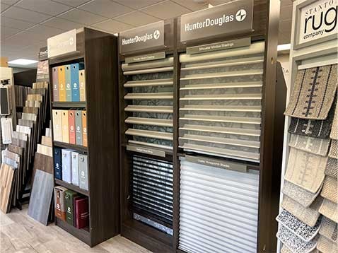 Store interior showcasing several different types of window coverings